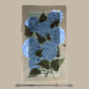 Hand-painted Jewelry Cabinet - Hydrangea Design on a weathered gray solid wood case with a decorative fiberglass screen door as the earring holder surface. Interior jewelry hooks are included inside (not visible) and a matching jewelry bar hangs from the case.
