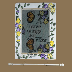 Hand-painted jewelry organizer - Portrait Series Brave Wings Design - on a white distressed solid wood frame and a decorative fiberglass screen as the earring holder surface. A matching jewelry bar hangs from the frame.