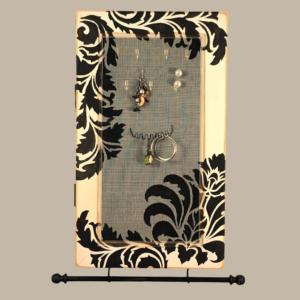 Hand-painted Jewelry Cabinet - Damask Design on a white distressed solid wood case with a decorative fiberglass screen door as the earring holder surface. Interior jewelry hooks are included (not visible) and a matching jewelry bar hangs from the case.