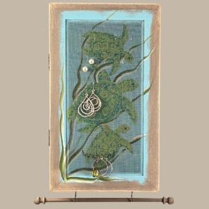 Hand-painted Jewelry Cabinet - Sea Turtles Design on a weathered gray solid wood case with a decorative fiberglass screen door as the earring holder surface. Interior jewelry hooks are included (not visible) and a matching jewelry bar hangs from the case.