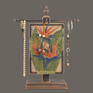 Hand-painted Earring Holder with Bird of Paradise Design — black distressed wood frame with fiberglass screen earring display area hanging on matching necklace stand. Handmade in Michigan.