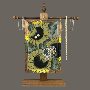 Hand-painted Earring Holder — Sunflowers Design on walnut stained wood frame and fiberglass earring display screen hanging on a matching necklace stand. Handmade in Michigan.