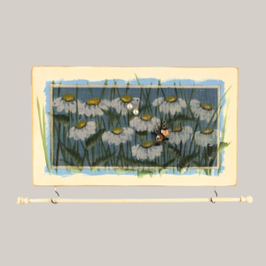 Hand-painted jewelry organizer - Studio Series Daisies Design - on a white distressed solid wood frame and a decorative fiberglass screen as the earring holder surface. A matching jewelry bar hangs from the frame.