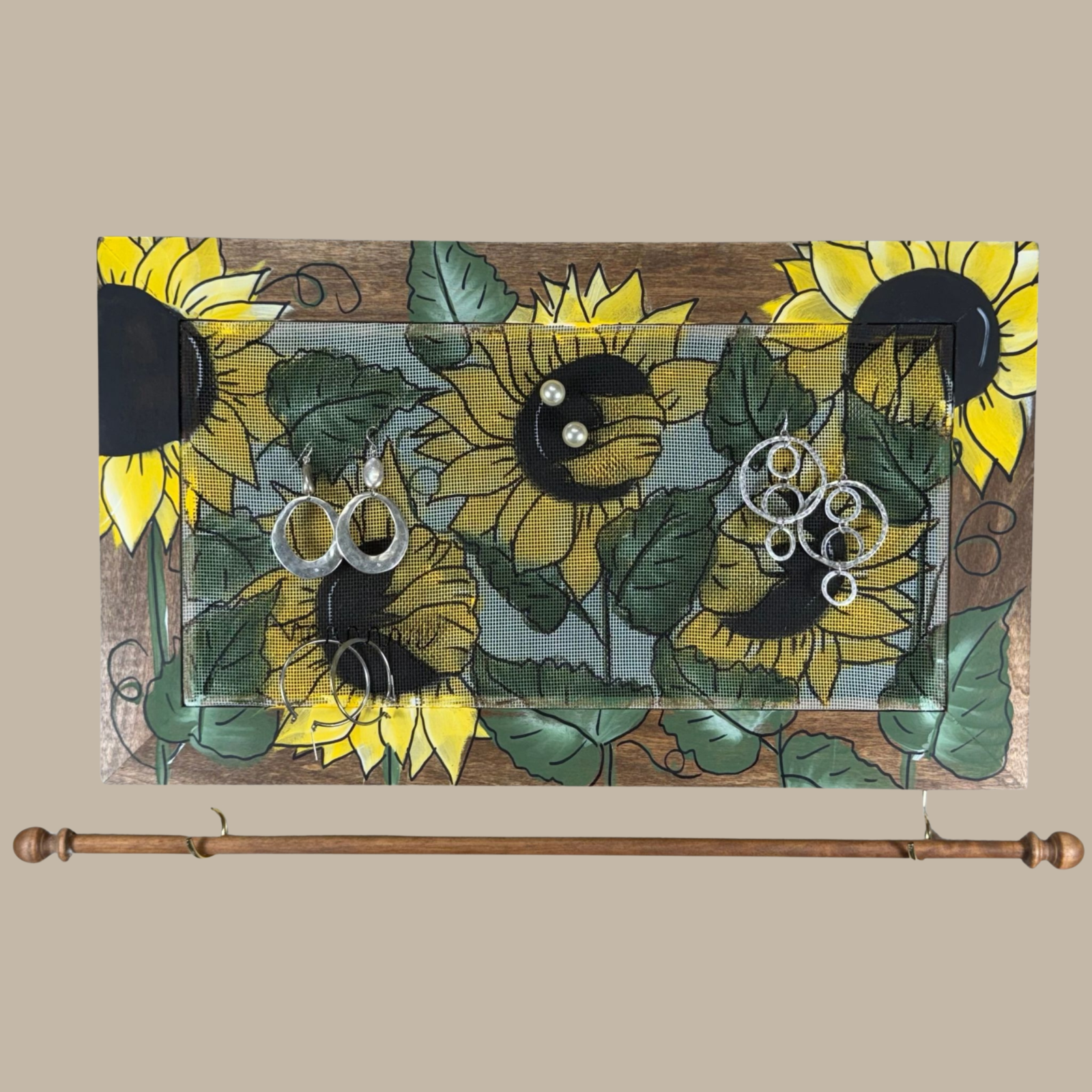 Hand-painted jewelry organizer - Studio Series Sunflowers Design - on a walnut stained solid wood frame and a decorative fiberglass screen as the earring holder surface. A matching jewelry bar hangs from the frame.