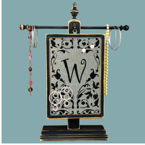 Personalized Hand-painted Earring Holder with Aida Design — distressed black wood frame with fiberglass screen earring display area hanging on matching necklace stand. Handmade in Michigan.